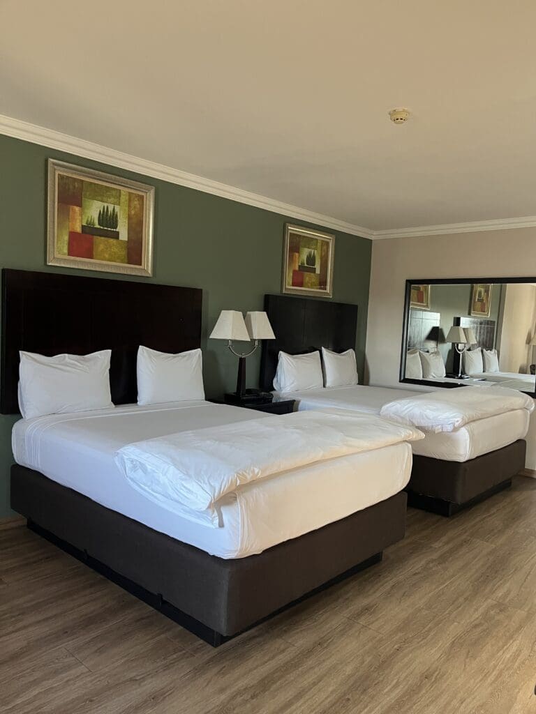 2 Queen beds with linen sheets and covers